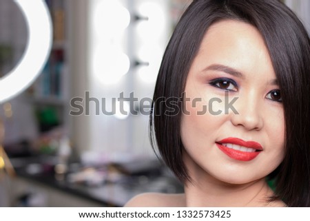 brunette girl has red lips, makeup face