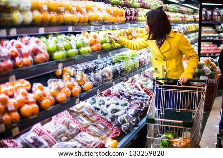 Young woman shopping in the supermarket Royalty-Free Stock Photo #133259828