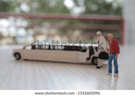 a  small figure sit in the toy car