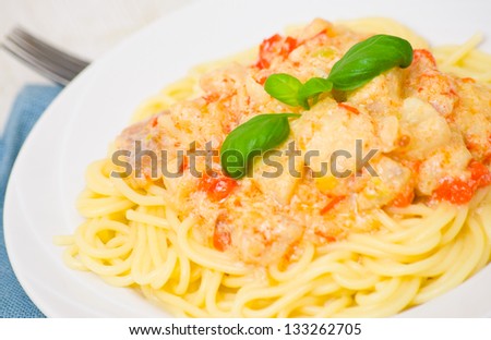 spaghetti with fish, vegetables and cream sauce