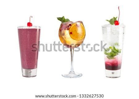 A variety of alcoholic drinks, beverages and cocktails on a white background. Three different drinks in glass goblets decorated with berries. Isolated.