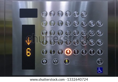 Round floor push buttons control panel inside the elevator in office building.