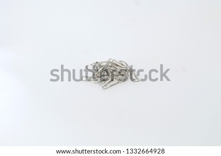 shiny silver paper clips made of iron to clamp paper as work and office supplies
