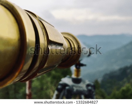 Its an image of a vintage telescope in focus and a nice scenery in background. Taken with an ipad pro.