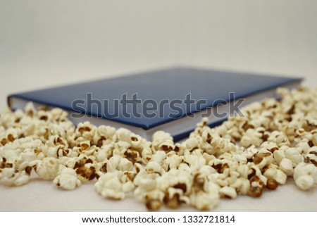Book and Popcorn on white