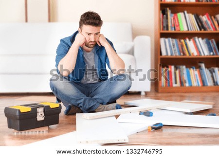 Man portrait and do it yourself furniture assembly Royalty-Free Stock Photo #1332746795