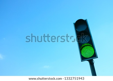 Traffic Light with Green Light On. Stoplight Against Blue Sky. Stop Light with Copy Space