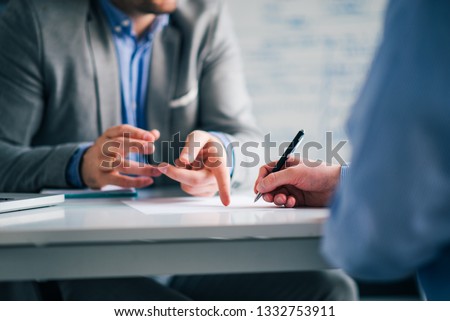 Business consultant and customer on a meeting in the office, signing contract.