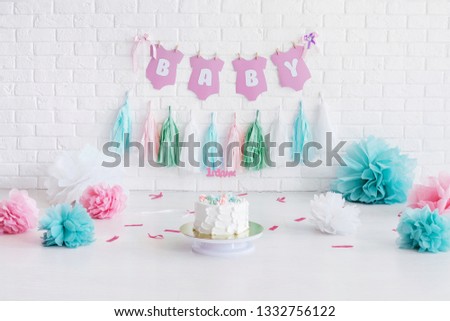 Decorated area for first baby birthday with a white stone wallfor on background. For smash cake photosession. Royalty-Free Stock Photo #1332756122