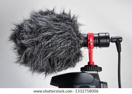 Professional Cardioid Directional Condenser Video Microphone black color attach on DSRL camera isolated on withe.