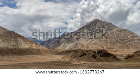 Leh, Ladakh / India: A desolate, high mountain  desert region of the Himalayas. Along the highway are  ranges with stunning sand and rock formations, streams, snow-peaks and glaciers