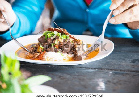 People eating spicy Northern Thai style noodle set - Thai food concept