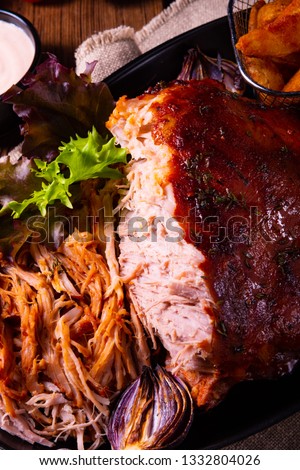 delicious pulled pork with baked potato quarters