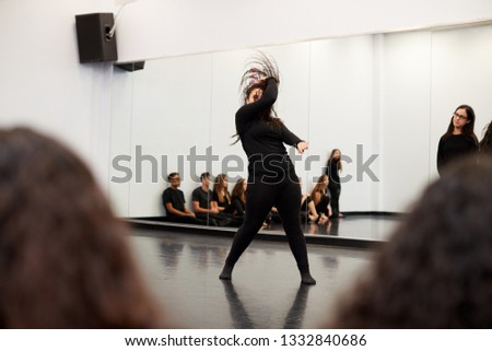 Female Student At Performing Arts School Performs Street Dance For Class And Teacher In Dance Studio