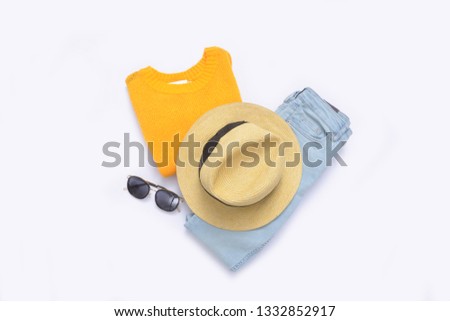 yellow sweater with hat ,sunglasses, blue jeans on white background