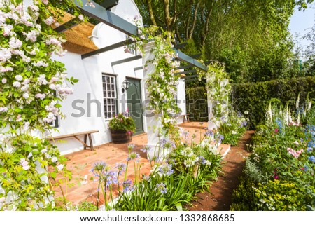 Garden landscape with flowerbed and entrance area
