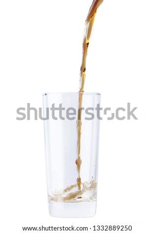 cola pouring in glass isolated on white back
