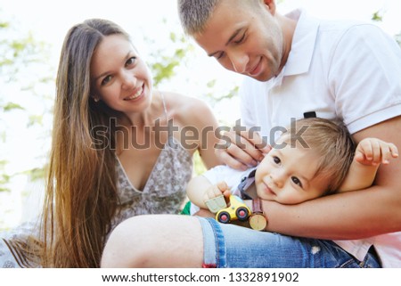 Family with one baby playing in the park