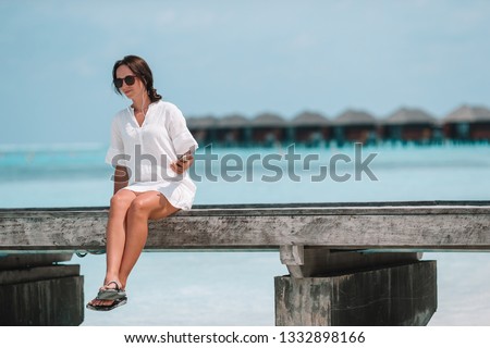 Young beautiful woman relaxing at white sand tropical beach