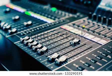 Part of an audio sound mixer with buttons and sliders . A little of DOF. Royalty-Free Stock Photo #133290191