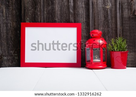 red picture frame blank, lantern, lavender decoration, white table, weathered wooden wall