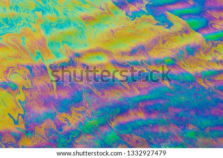 Abstract multicolored gasoline stains on water surface
