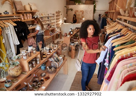 Customers Browsing In Independent Clothing And Gift Store Royalty-Free Stock Photo #1332927902