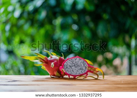 Fresh dragon fruit or pitahaya on wooden table.