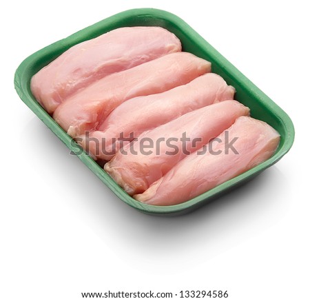 Raw chicken fillet in a green tray over white background Royalty-Free Stock Photo #133294586