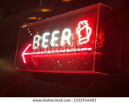 illuminated beer sign with arrow