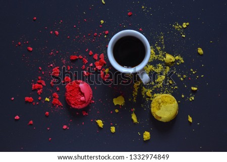 White Cup with fragrant coffee on the background of beautiful pieces of cookies scattered on the table