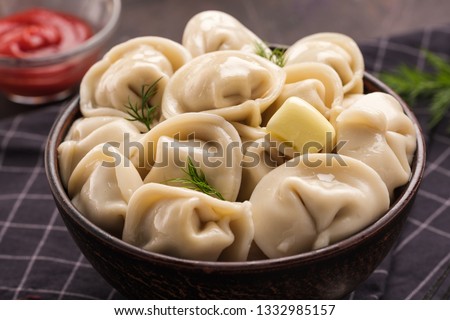 Homemade meat dumplings - russian pelmeni. Dumplings, filled with meat, ravioli. Dumplings with filling. Close-up. Royalty-Free Stock Photo #1332985157