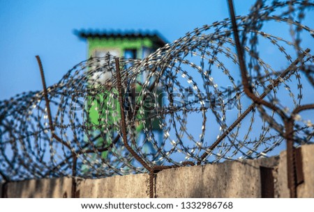 guard behind barbed wire