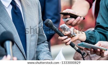 Media Interview - journalists with microphones interviewing formal dressed politician or businessman. Royalty-Free Stock Photo #1333000829