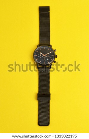 Wristwatch on yellow background