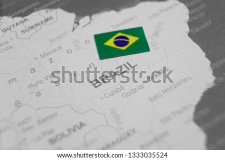 Brazilian flag placed on Brazil map of world map