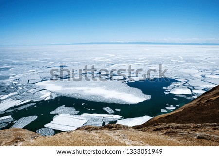 View above big beautiful lake Baikal with Ice floes floating on the water in spring, Russia