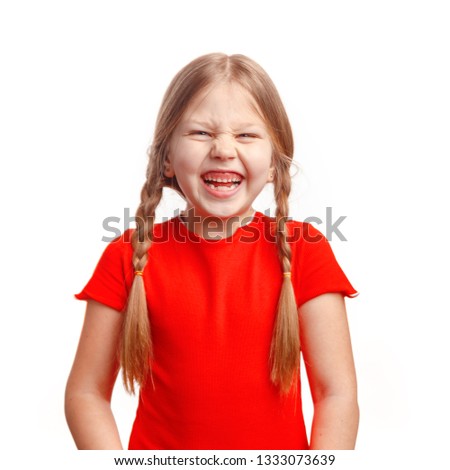 Cute little girl 5-6 years old posing and laughing in the studio on a white background