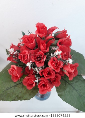 vase with delicate small red roses