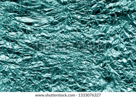 Metal foil texture in cyan color. Abstract background and texture for design.