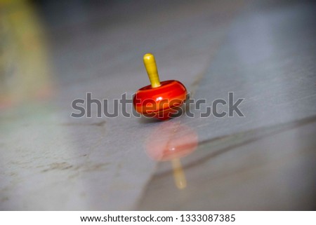 Retro colorful wooden spinning top toy on floor