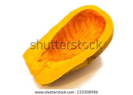 A pumpkin on the table in front of a window