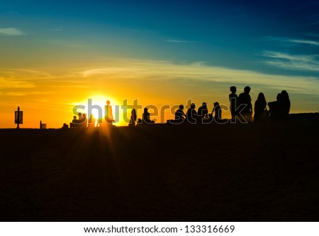 People and sun in back light