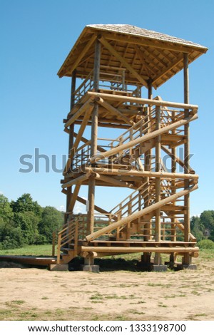 Open-air wooden viewing tower construction in landscape design of nature. Example of simple architecture building for panoramic views in the national reservoir or park.
