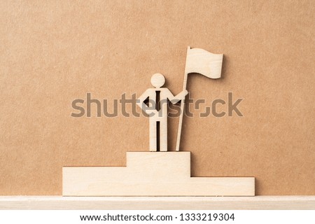 Business and design concept - group of wooden businessman icon with flag on kraft paper. it's conversation, leadership and teamwork concept
