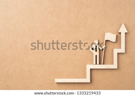 Business and design concept - group of wooden businessman icon with arrow on kraft paper. it's conversation, leadership and teamwork concept
