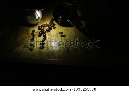 coffee beans on a wooden table with low light