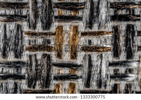 woven mats on the floor of the house, made of fiber yarn, colored in silver and black, with fence-shaped textures, taken by using macro cameras with magnification to show woven details