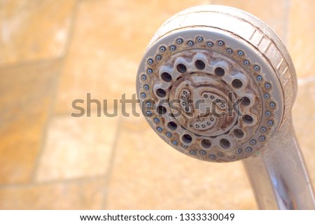 Hard water stain and rust on old shower tap in the bathroom. Sanitary, health care concept. Copy space for any text design. Royalty-Free Stock Photo #1333330049