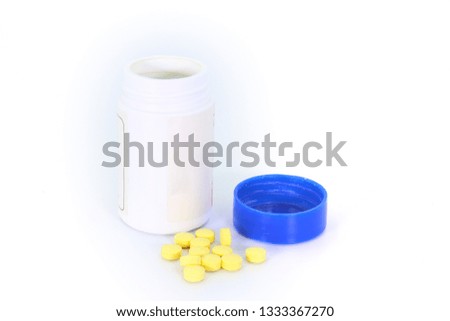 Tablets medicine pill are scattered on white background.